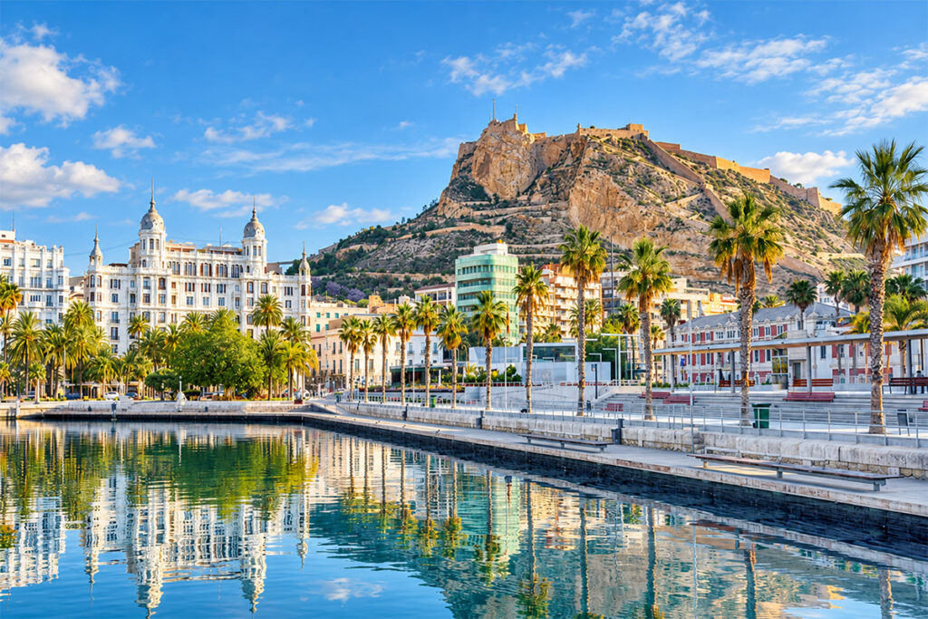 Alicante's harbour and palm-lined seafront, with the castle on Monte Benacantil behind