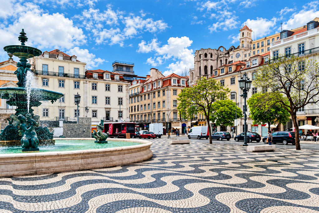 The wave-patterned pavement and fountain of Rossio square in the Baixa