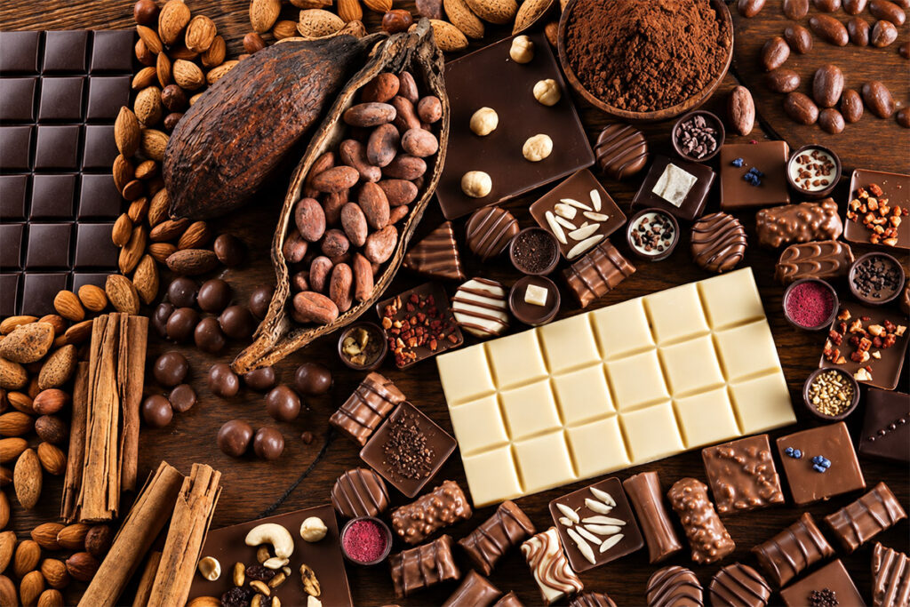 Cocoa pods, beans and an assortment of chocolate