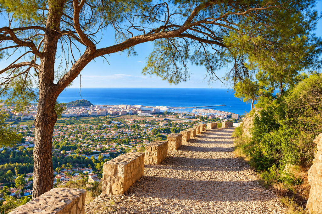A stone-lined trail on the Montgó, with Dénia and the sea below