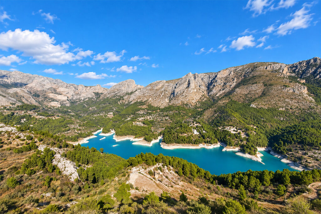 The turquoise Guadalest reservoir winding through the mountains
