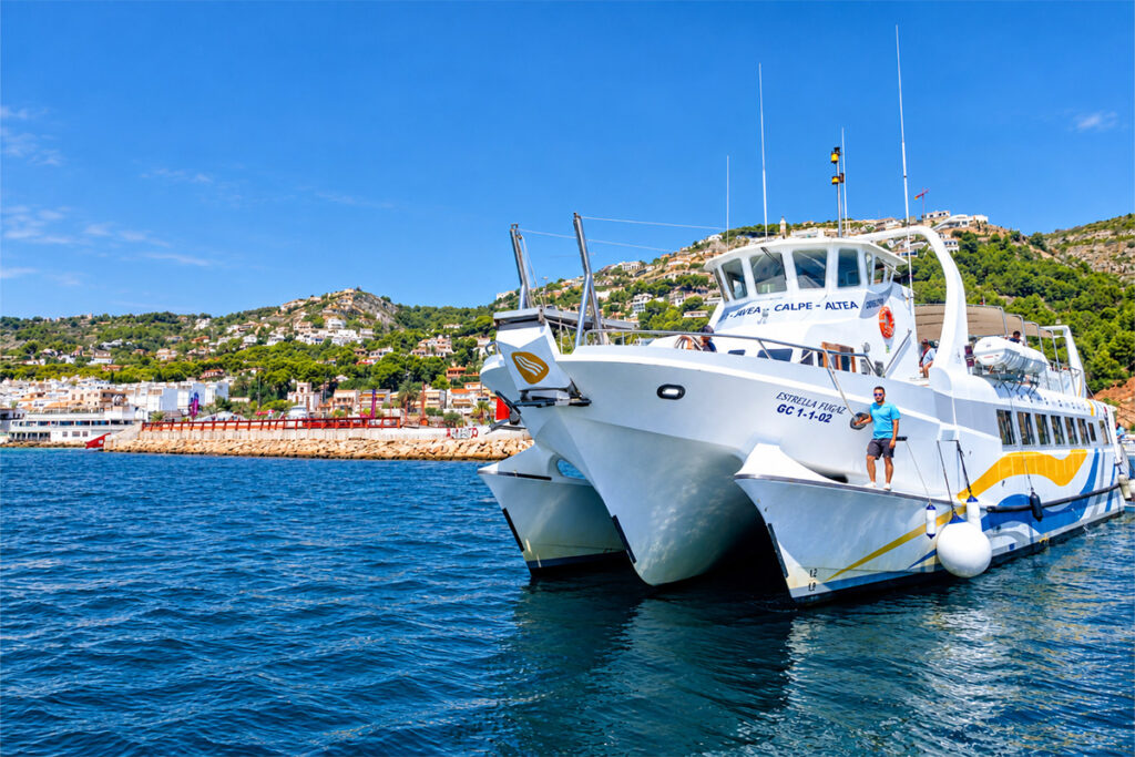 An excursion catamaran moored in the harbour at Dénia