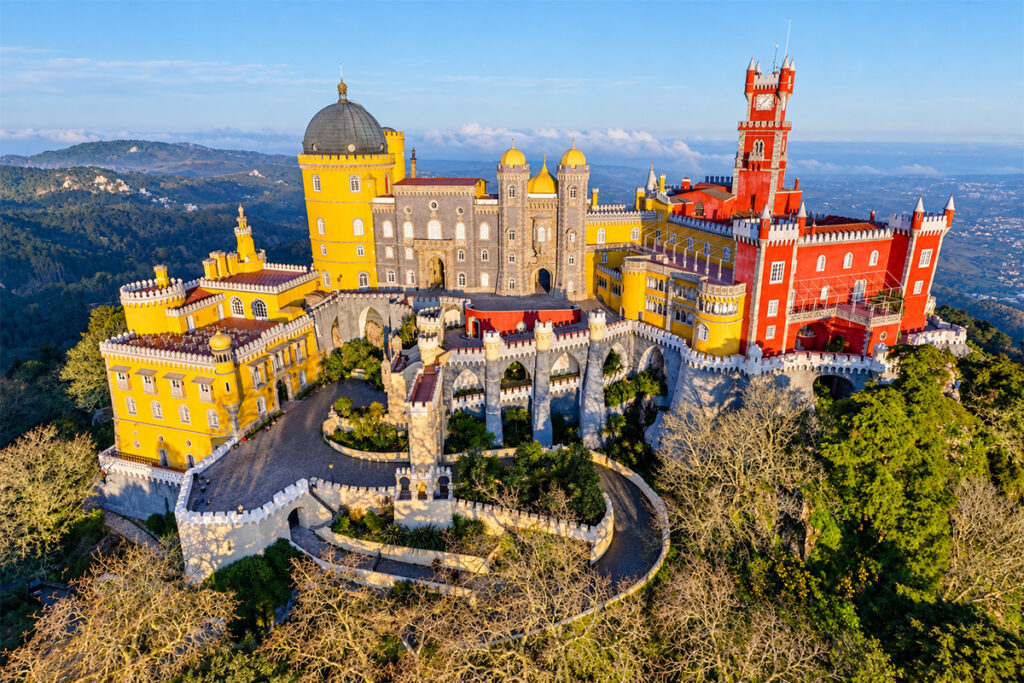 Aerial view of the Palácio da Pena, painted red and yellow above Sintra