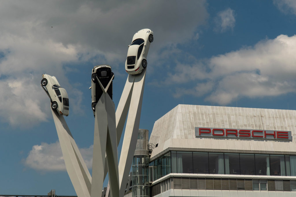 The Inspiration 911 sculpture with three cars on angled poles outside the Porsche Museum