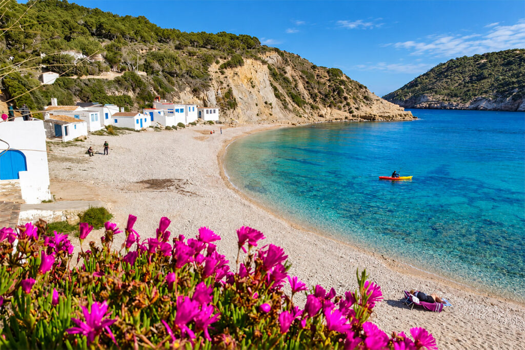 The fishermen's huts and clear water of the Cala del Portitxol