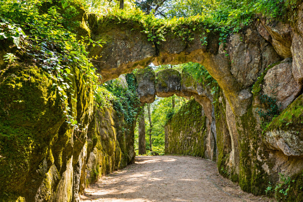 A moss-covered stone tunnel in the gardens of the Quinta da Regaleira