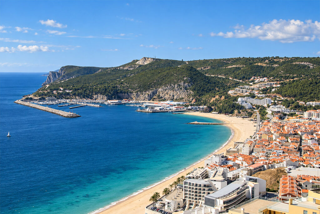 Aerial view of Sesimbra's bay, beach and hilltop castle