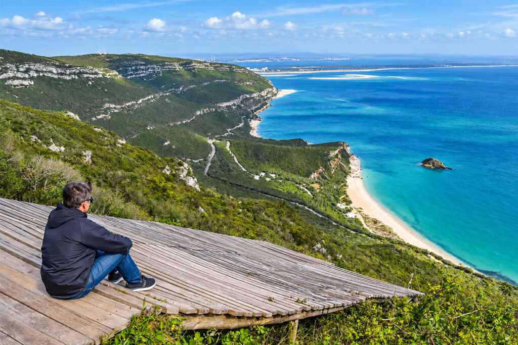A viewpoint over the green ridge and turquoise coast of the Serra da Arrábida