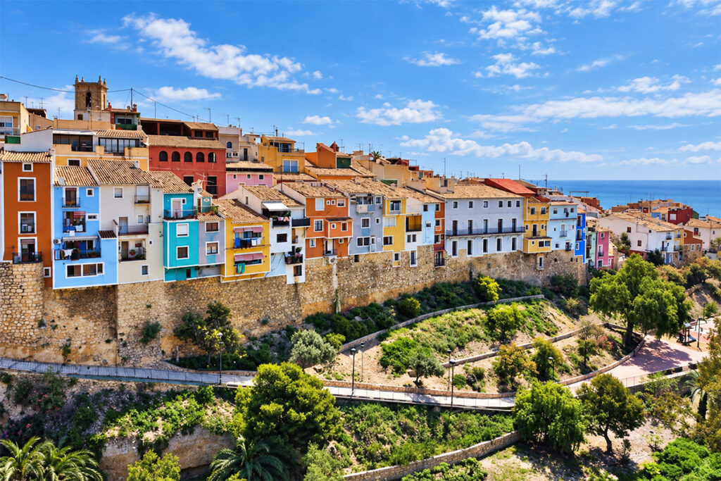 Aerial view of Villajoyosa's coloured houses along the old town wall above the sea
