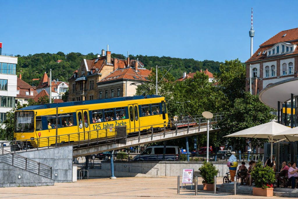 The yellow Zahnradbahn, the Zacke, climbing from Marienplatz with the Fernsehturm behind